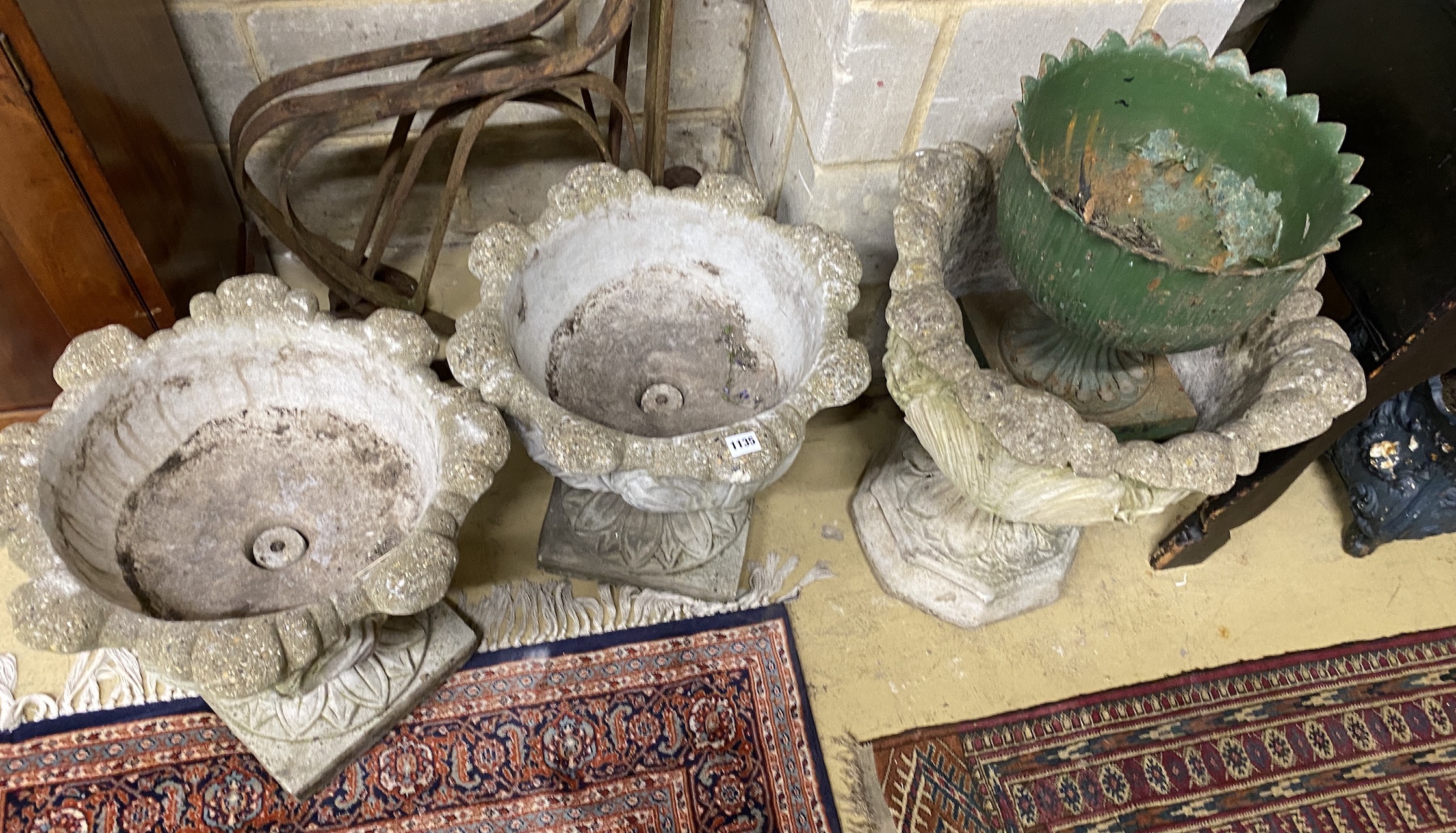 A pair of reconstituted stone acanthus garden planters, a similar larger planter and a cast iron urn, largest diameter 50cm, height 58cm